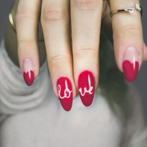 selective focus photography of woman's pink manicure